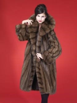 A woman wearing a fabulous Russian sable fur coat with black skinny jeans. 